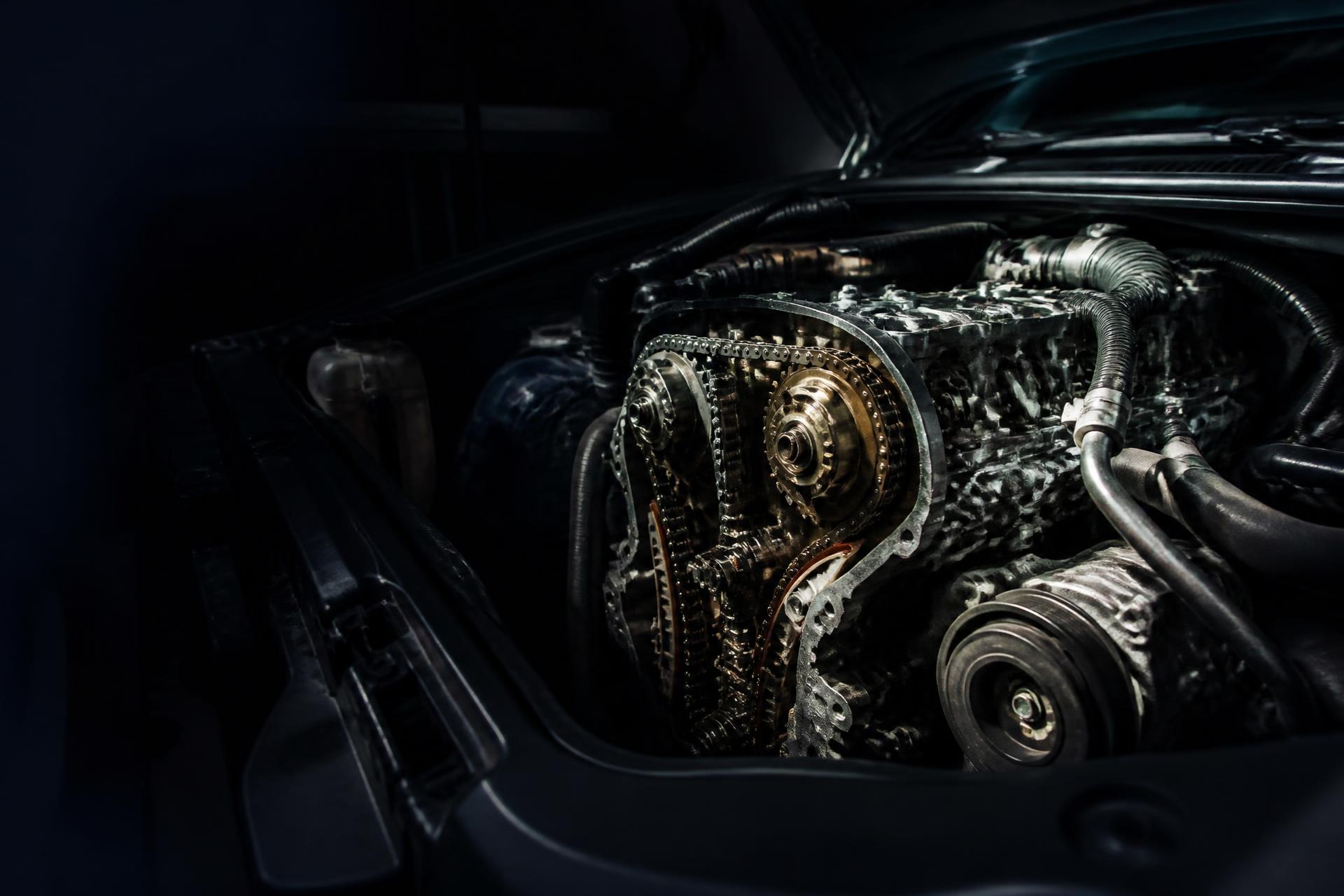 Timing chain and camshaft gears exposed on a car engine with the timing cover removed